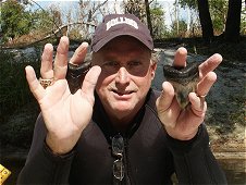 Diving & Digging for Fossils - John Rollins with two nice Meg teeth found in south Florida creek in 2007.
