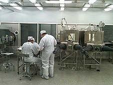NASA - JSC Visit - Scientsts working inside the lunar sample vault.