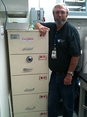 NASA - JSC Visit - Everett with his office safe containing moon and Martian samples.