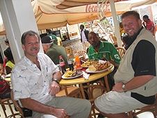 Thika, Kenya Expedition - Greg, Mike and Robert enjoying a tasty meal after cleaning up.