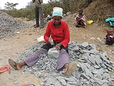 Thika, Kenya Expedition - Woman turning large fragments into smaller ones for use in roads.
