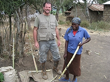 Thika, Kenya Expedition - Woman trimming sugar cane for me to try.