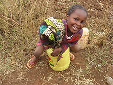 Thika, Kenya Expedition - Little girl sitting on a bucket making us laugh.