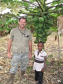 Thika, Kenya Expedition - Greg with helper by a papaya tree.
