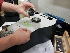 UCF Laboratory - Tissint stone in the removable chamber that will be inserted and sealed into the pycnometer.